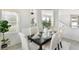 The dining room features six chairs, a black table, and a view into the living room at 2563 Lamar Valley St, Apopka, FL 32703