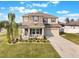 Charming two-story home with stone accents, front porch, manicured lawn, and a two-car garage at 2563 Lamar Valley St, Apopka, FL 32703