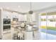 Modern kitchen featuring white cabinets, granite countertops, stainless steel appliances, and a kitchen island at 2563 Lamar Valley St, Apopka, FL 32703