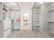 Organized walk-in closet with ample shelving and storage solutions, plus a view to the main bathroom at 2563 Lamar Valley St, Apopka, FL 32703