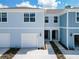 Charming two-story townhome featuring a one-car garage and inviting front entrances at 2865 Clever Ln, Winter Park, FL 32792