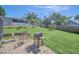 Cozy backyard patio with outdoor furniture and a grill, ideal for entertaining and relaxing outdoors at 2204 Clementine Trl, Clermont, FL 34714
