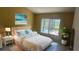 Comfortable bedroom with neutral tones, a queen bed and a sunlit window view at 2204 Clementine Trl, Clermont, FL 34714