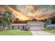Charming single-story home with a well-manicured lawn, attached garage, and inviting curb appeal at 2204 Clementine Trl, Clermont, FL 34714