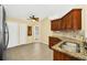 Eat-in kitchen featuring granite countertops, stainless sink, tile flooring and lots of cabinet storage at 2204 Clementine Trl, Clermont, FL 34714