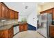 Updated eat-in kitchen features granite countertops, stainless appliances, wood cabinets and tile flooring at 2204 Clementine Trl, Clermont, FL 34714