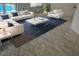Stylish living room with modern furniture, area rug, hardwood flooring, and poolside views at 2204 Clementine Trl, Clermont, FL 34714