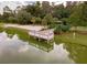Scenic lake view with a charming boardwalk leading to a gazebo, enhancing community recreation at 1055 Lake Berkley Dr, Kissimmee, FL 34746