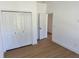 Bright bedroom with wood-look floors, bi-fold closet doors and white trim at 13882 Sw 56Th Ln, Ocala, FL 34482