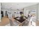 Open-concept dining room with stylish table, chairs, and sliding glass doors leading to the backyard at 13882 Sw 56Th Ln, Ocala, FL 34482