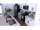 Modern kitchen boasts stainless steel appliances, sleek countertops, and white cabinetry at 13882 Sw 56Th Ln, Ocala, FL 34482