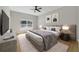 Serene main bedroom featuring a large window, decorative art, and an upholstered headboard at 13882 Sw 56Th Ln, Ocala, FL 34482