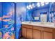 Bathroom features marine-themed decor, double sinks, and tile shower at 1473 Moon Valley Dr, Davenport, FL 33896