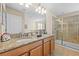 Bathroom featuring a double sink vanity, granite countertops, and a glass enclosed walk-in shower at 1473 Moon Valley Dr, Davenport, FL 33896