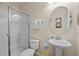 Bathroom with shower, toilet, and pedestal sink at 1473 Moon Valley Dr, Davenport, FL 33896