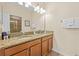 Double vanity bathroom with granite countertops, tile floors, and lots of light at 1473 Moon Valley Dr, Davenport, FL 33896