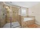 Spa-like bathroom featuring a glass enclosed shower and a separate soaking tub at 1473 Moon Valley Dr, Davenport, FL 33896