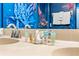 Bathroom vanity featuring dual sinks and an array of elegant toiletries for a spa-like experience at 1473 Moon Valley Dr, Davenport, FL 33896