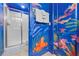 Shower room featuring ocean themed artwork and shower stall with glass door at 1473 Moon Valley Dr, Davenport, FL 33896