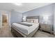Well-lit bedroom with modern furnishings, decorative pillows, and an adjacent bathroom at 1473 Moon Valley Dr, Davenport, FL 33896