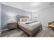 Comfortable bedroom featuring a queen-sized bed, stylish decor, and ample natural light at 1473 Moon Valley Dr, Davenport, FL 33896