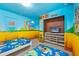 Themed bedroom with twin beds, Mario murals, and TV at 1473 Moon Valley Dr, Davenport, FL 33896