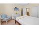 Bedroom featuring a white dresser, patterned chair, TV, and a connecting bathroom at 1473 Moon Valley Dr, Davenport, FL 33896