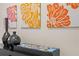 Decor features black vases, colorful artwork, and travel brochures on a shelf at 1473 Moon Valley Dr, Davenport, FL 33896