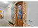 Hallway featuring a decorative, arched doorway with stone-like detail and painted mural at 1473 Moon Valley Dr, Davenport, FL 33896