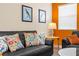Living room featuring a black leather sofa with colorful decorative pillows and a lamp at 1473 Moon Valley Dr, Davenport, FL 33896