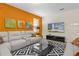 Modern living room boasts white sofas, black accent rug, and mounted television at 1473 Moon Valley Dr, Davenport, FL 33896