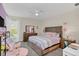 Cozy bedroom with a large bed, wood dresser, and a pink accent rug at 4001 Ainsley Ave, Orlando, FL 32833