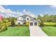Beautiful exterior elevation of a home with a manicured lawn, mature trees, and a spacious driveway at 4001 Ainsley Ave, Orlando, FL 32833