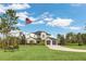 Inviting two-story home with manicured lawn and a flag, featuring stone and siding exterior at 4001 Ainsley Ave, Orlando, FL 32833