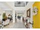 Bright foyer with tall ceilings, tiled floors, decorative mirror, and a glimpse into the dining and living areas at 4001 Ainsley Ave, Orlando, FL 32833