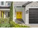 Charming front entrance with bright yellow double doors, stone accents, and manicured landscaping at 4001 Ainsley Ave, Orlando, FL 32833