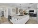 Bright, open kitchen boasts an island, white cabinetry, and modern appliances at 4001 Ainsley Ave, Orlando, FL 32833