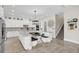 Bright kitchen with stainless steel appliances, custom island with seating, and convenient access to stairs at 4001 Ainsley Ave, Orlando, FL 32833