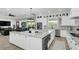 Open concept kitchen with marble countertops, white cabinetry, and modern appliances that flows into the living area at 4001 Ainsley Ave, Orlando, FL 32833
