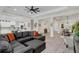 Inviting living room featuring a leather sectional sofa that flows into the dining and kitchen areas at 4001 Ainsley Ave, Orlando, FL 32833