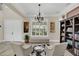 Cozy seating area with decorative touches, a large window, and access to the dining area at 4001 Ainsley Ave, Orlando, FL 32833