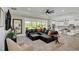 Bright living room featuring a comfortable leather sectional sofa, pool views, and elegant decor at 4001 Ainsley Ave, Orlando, FL 32833