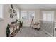 Comfortable loft area with a chair, console table, plants, decorative art and plenty of natural light at 4001 Ainsley Ave, Orlando, FL 32833