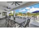 Covered patio features ample seating around the outdoor kitchen and is perfect for al fresco dining and entertaining at 4001 Ainsley Ave, Orlando, FL 32833