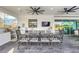 Covered patio with an outdoor kitchen, barbecue, and ample seating for dining and entertaining at 4001 Ainsley Ave, Orlando, FL 32833