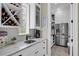 Butler's pantry featuring wine rack, coffee bar and stainless refrigerator with ample storage at 4001 Ainsley Ave, Orlando, FL 32833