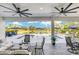 Covered patio featuring ceiling fans, comfortable seating, and a view of the pool and landscaped grounds at 4001 Ainsley Ave, Orlando, FL 32833