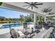Spacious covered patio with seating areas, pool, spa, and outdoor kitchen, perfect for entertaining at 4001 Ainsley Ave, Orlando, FL 32833