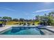 Sparkling pool and spa offer a relaxing outdoor space with a lush, private backyard view at 4001 Ainsley Ave, Orlando, FL 32833
