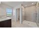 Modern bathroom featuring a glass-enclosed shower, dark wood vanity, and double sinks at 7247 Rolling Leaf Rd, Groveland, FL 34736